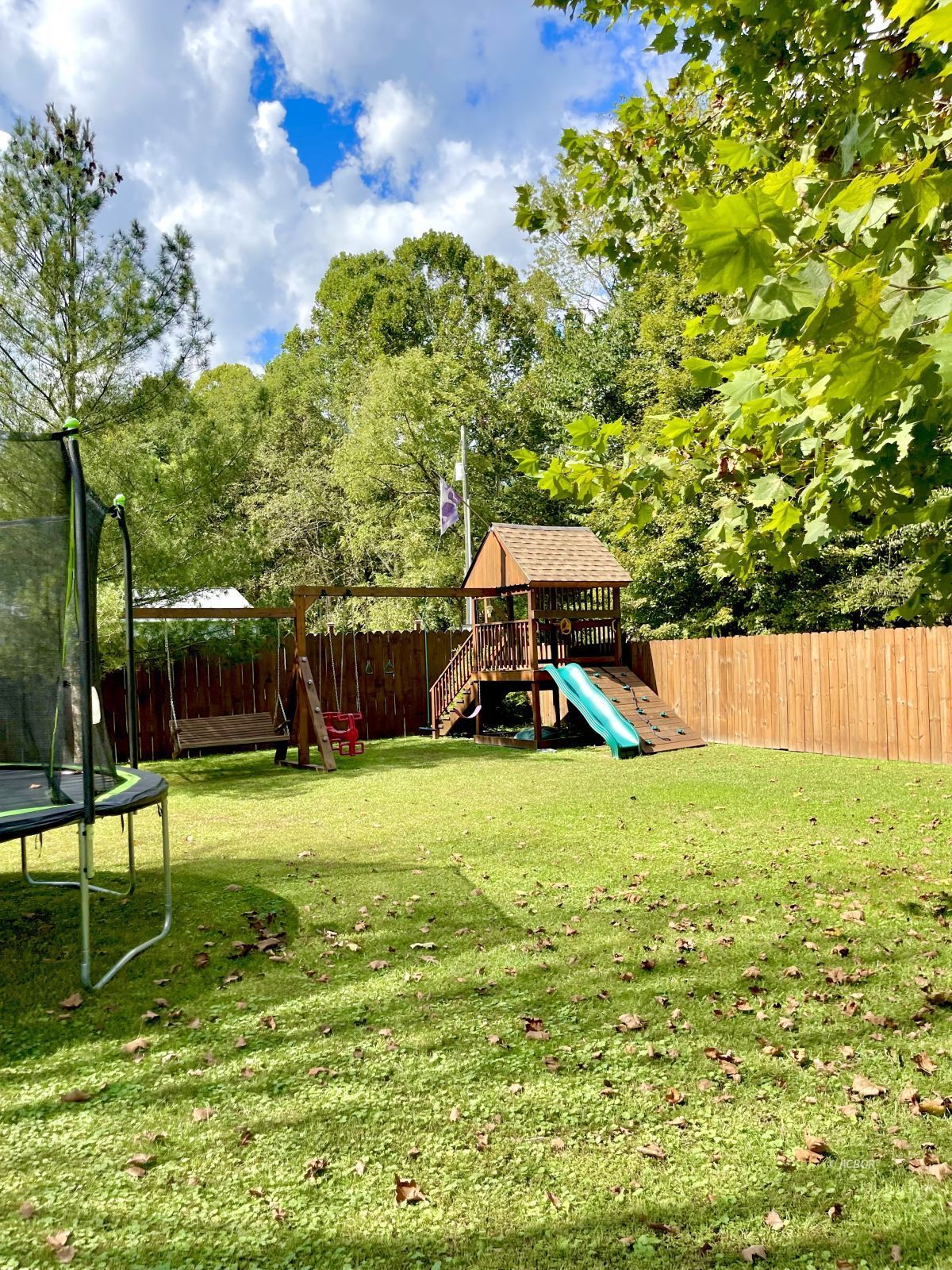 Swing Set in Fenced Front Yard